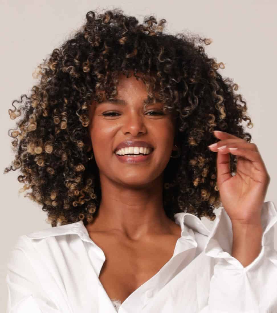 Happy Black Curly Hair Woman Posing Infront of Camera | Glowtox in New York, NY