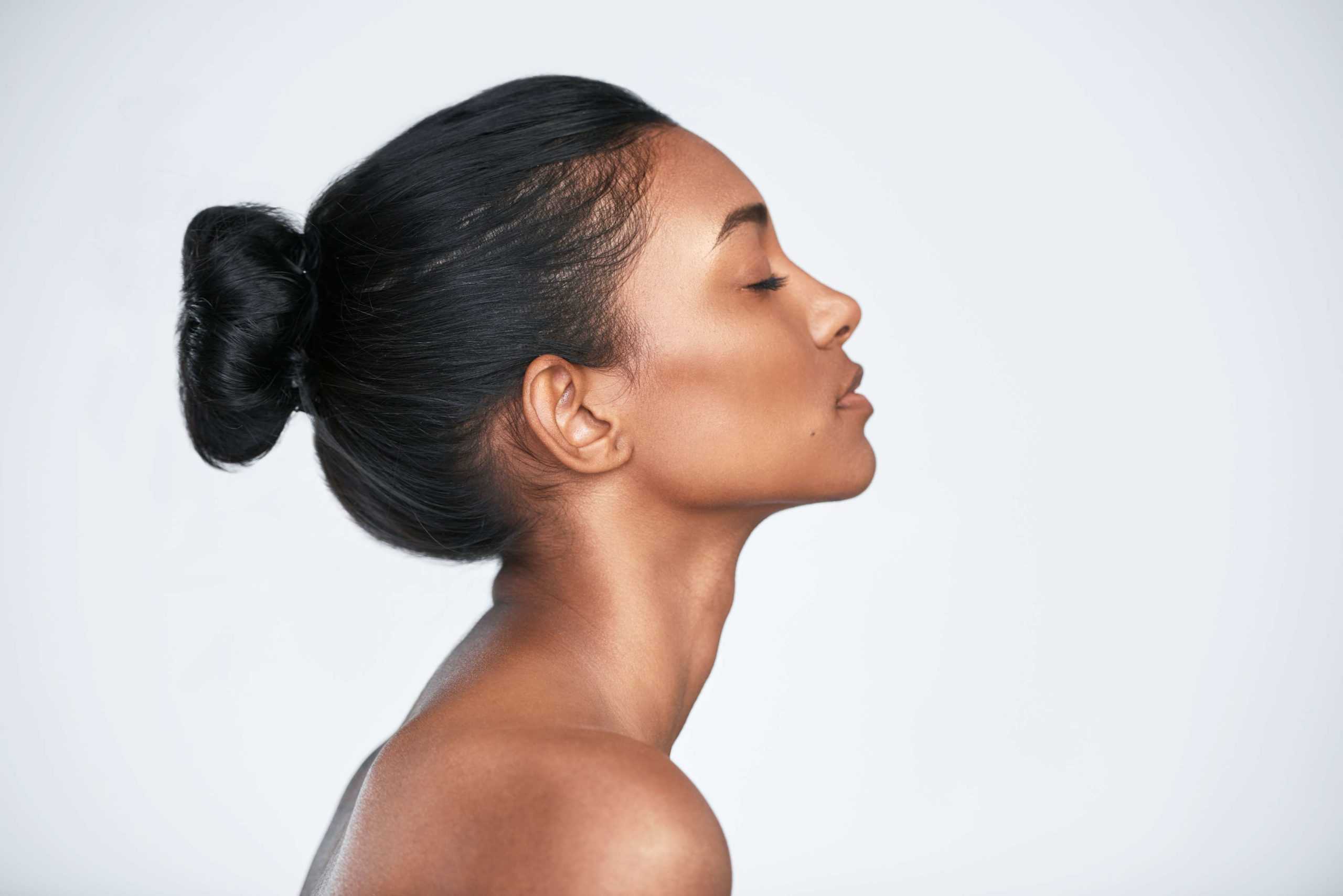 Closed Eye Young Woman with Hair Bun | Glowtox in New York, NY